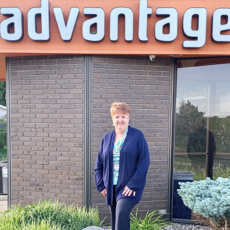Karen Powell standing in front of an Advantage ATM.
